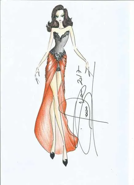 O modelo é para arrasar em uma festa. Vestido tubo com comprimento curto, no decote e na região da cintura, além dos recortes tem aplicações em renda. O detalhe está na leveza do crepe que envolve o corpo se transformando em uma saia.